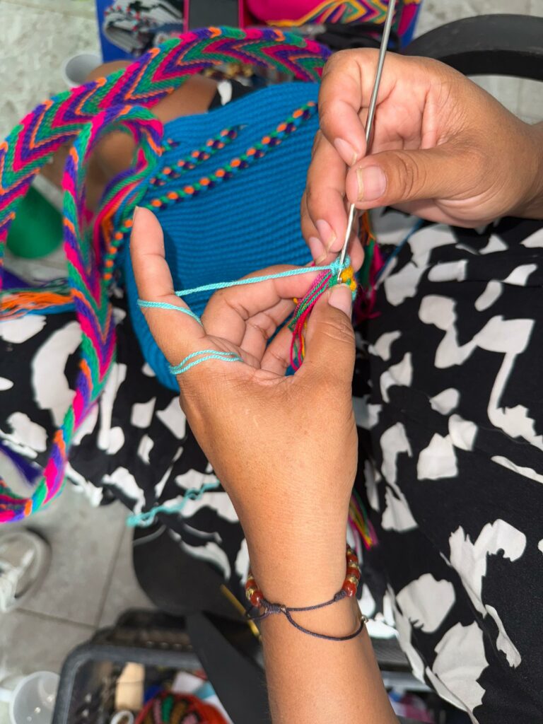 A woman weaving Wayuu bags crochet with her meaningful technique