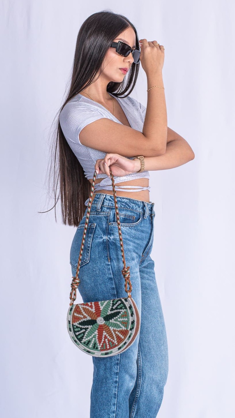 Viola Moon Wayuu Bag, handmade crescent-shaped Colombian bag in gray, brown, and mint green tones, woven by Wayuu artisans.