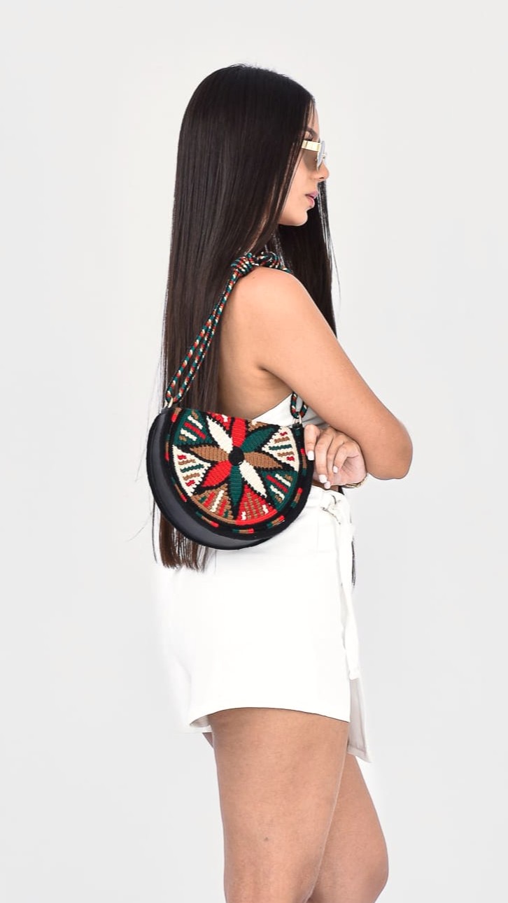 Madeleine Moon Wayuu Bag, handcrafted Colombian bag with a moon-shaped design in red, green, and beige tones, handmade by Wayuu artisans.