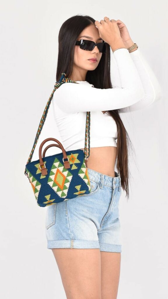 Eliza Wayuu Bag, handmade Colombian crochet bag in dark blue and green with leather details, versatile shoulder and crossbody straps.