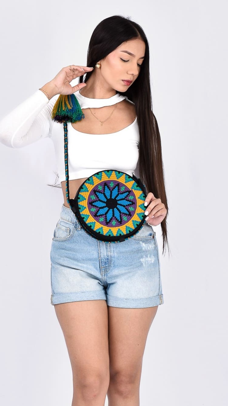 Maya Wayuu Round Bag, handmade Colombian bag with deep blue tones, geometric patterns, and round silhouette, crafted by Wayuu artisans.