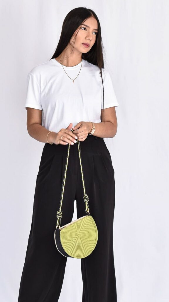 Noemi Moon Wayuu Bag, handcrafted Colombian bag with crescent shape, beige base, and green details woven by Wayuu artisans.